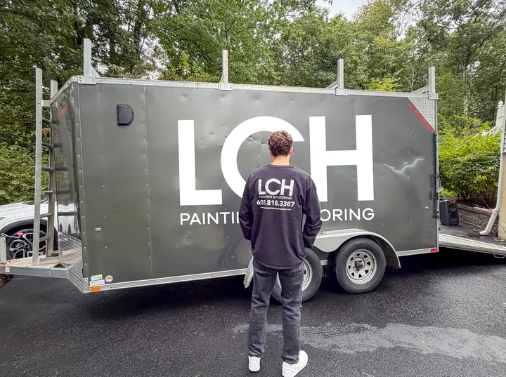 Jacob Cunningham of LCH Painting & Flooring in front of the LCH trailer