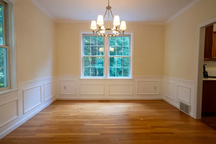Bedford, NH dining room with yellow walls above white wainscoting before LCH repainted it