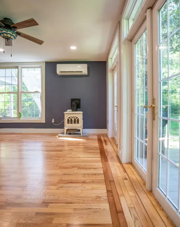 Hardwood floor running toward French doors after a full refinish