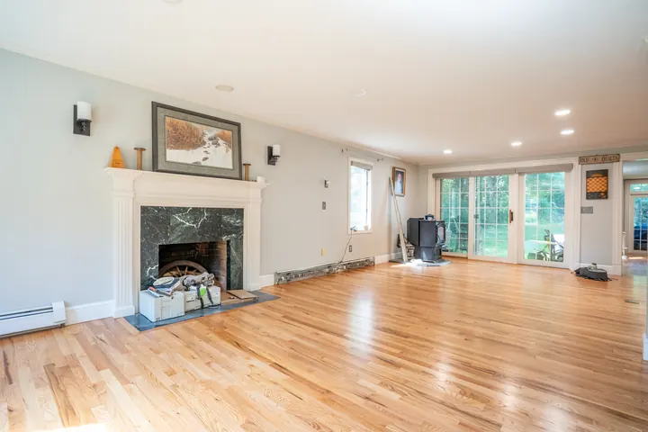 Living room with a fireplace and newly refinished hardwood floors