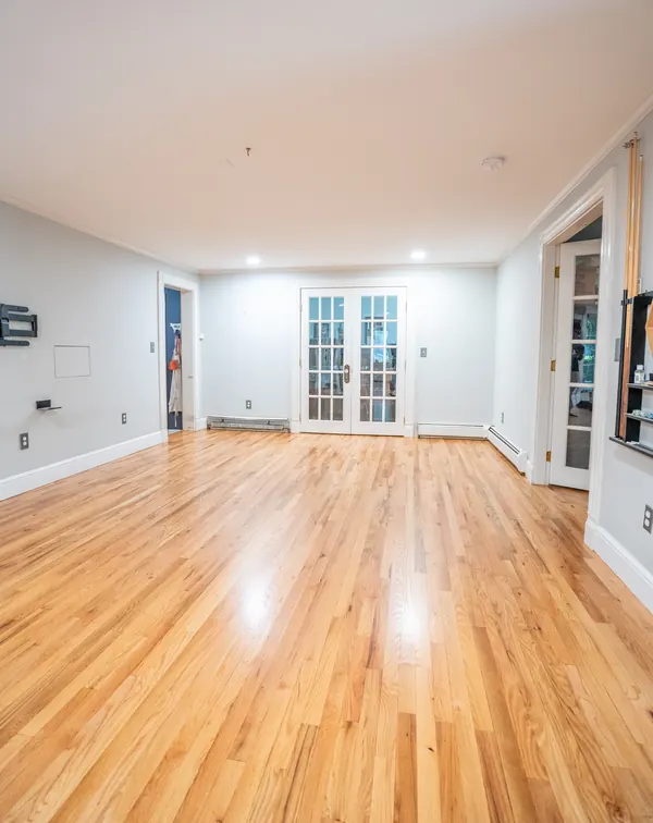 Long living room with freshly refinished natural red oak floors