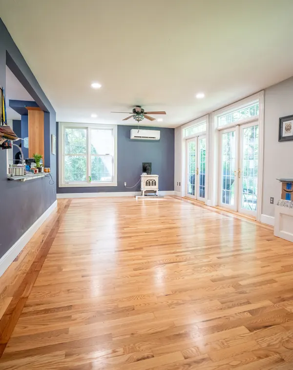 Sunroom with glossy refinished hardwood and French doors